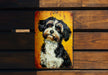 a painting of a black and white dog on a yellow sign