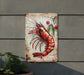 a metal sign with a lobster painted on it