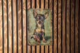a picture of a small dog on a wooden wall
