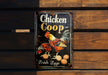 a chicken coop sign hanging on a wooden wall