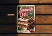a sandwich deli tin sitting on top of a wooden bench