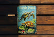 a picture of a turtle pond book on a bench