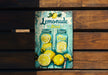 a picture of a lemonade sign on a wooden bench