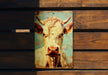 a painting of a cow on a wooden wall