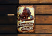 a sign on a wooden wall that says chocolate delights