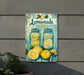 a picture of a lemonade sign on the side of a building