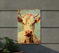 a picture of a cow on a wall