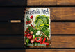 a vegetable patch sign hanging on a wooden wall