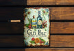 a metal sign with a bottle of gin on it