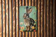 a picture of a rabbit on a wooden wall