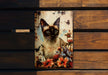 a picture of a siamese cat on a wooden bench