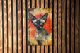 a painting of a cat on a wooden wall