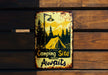 a sign on a wooden wall that says camping site awaits