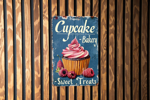 a sign on a wooden wall advertising cupcake bakery