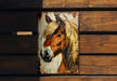 a picture of a horse on a wooden wall