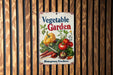 a vegetable garden sign hanging on a wooden wall