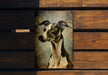 a picture of a dog hanging on a wooden wall