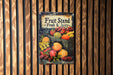 a fruit stand sign hanging on a wooden wall