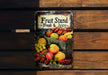 a metal sign with a bunch of fruit on it