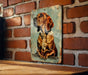 a picture of a dog hanging on a brick wall
