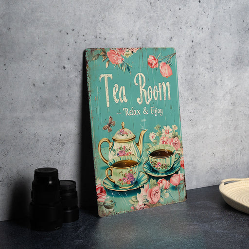 a tea room sign next to a cup of tea