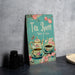 a tea room sign next to a cup of tea