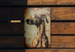 a picture of a dog on a rusted metal sign
