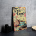 a picture of a tea room sign next to a cup and saucer