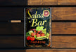 a sign on a wooden wall that says salad bar