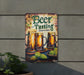 a beer sign hanging on the side of a building