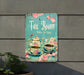 a tea room sign hanging on the side of a building