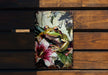 a frog sitting on top of a wooden bench