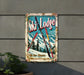 a ski lodge sign hanging on the side of a building