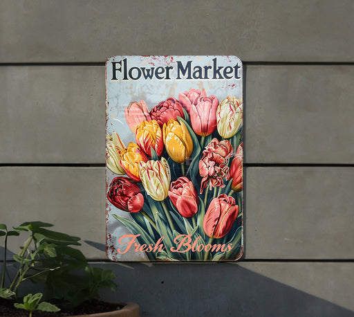 a flower market sign hanging on the side of a building