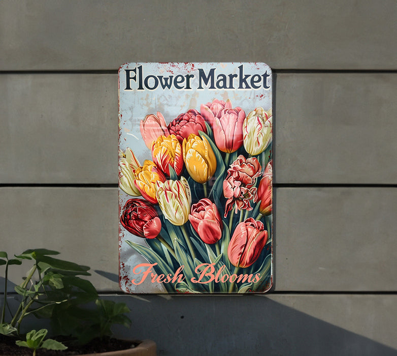 a flower market sign hanging on the side of a building