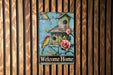 a welcome home sign on a wooden wall