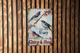 a sign on the side of a building with birds on it