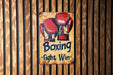 a sign on a wall that says boxing fight win