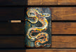 a sign with a snake painted on it