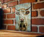 a picture of a cow on a brick wall