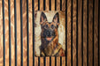 a picture of a german shepard on a wooden wall
