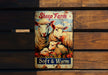 a picture of a sheep farm sign on a wooden bench