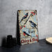 a metal sign with birds sitting on a branch
