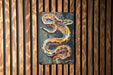 a painting of a snake on a wooden wall
