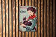 a vintage poster of a woman holding a cat