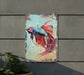 a painting of a siamese fish on a wall