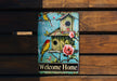 a welcome home sign on a wooden bench