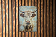 a picture of a cow on a wooden wall
