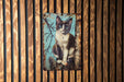 a picture of a cat on a wooden wall