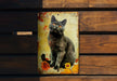 a black cat sitting on top of a wooden bench